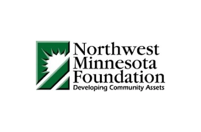 Logo of the Northwest Minnesota Foundation featuring a green square with a white sunburst and diagonal lines, next to the foundation's name and the tagline "Developing Community Assets.